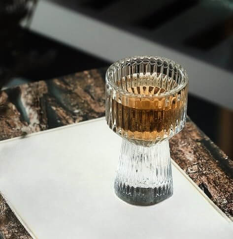 Golden drink hits the rim of the Mini Measure Shot Glass