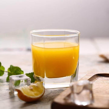 Fresh orange drink in a Crystal Square Shaped Glass