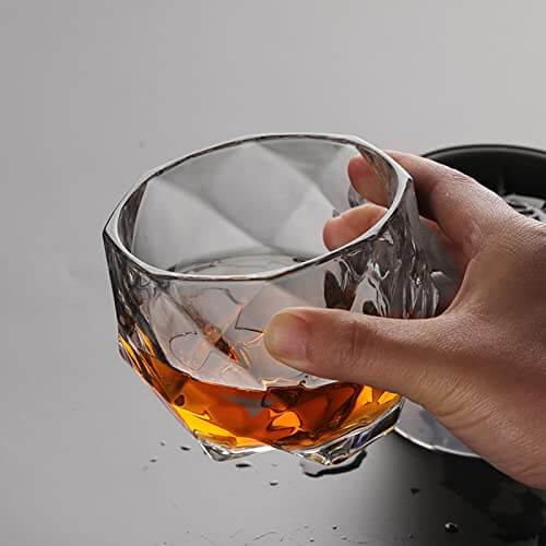Diamond Big Bowl Whiskey Glass held with amber drink
