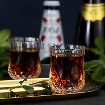 Crystal Shot Glass with dark drink on golden tray