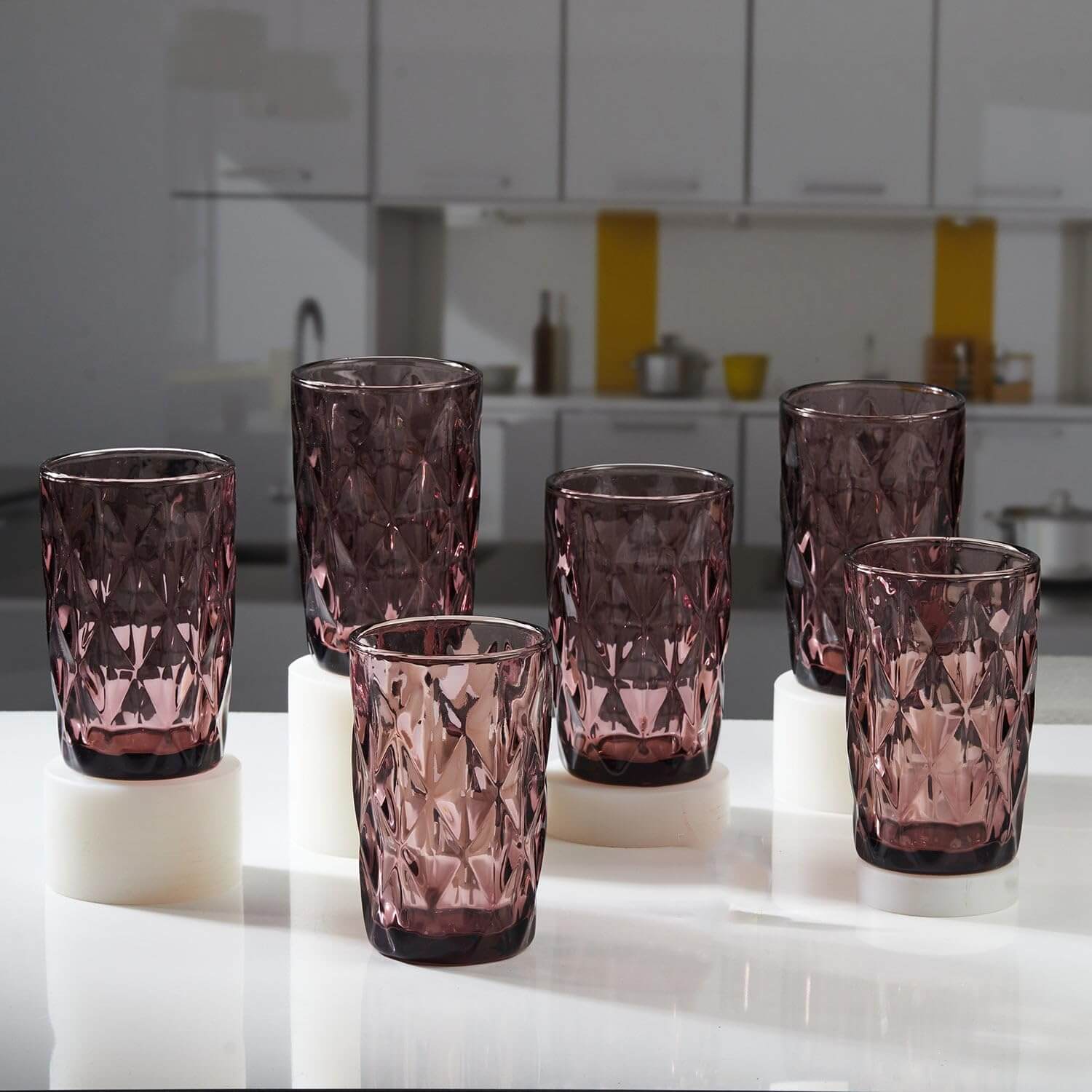 Elegant set of Diamond-Cut Pink Glass tumblers displayed