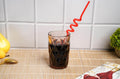 Cola served in Geometric Design Drinking Glasses with twist straw