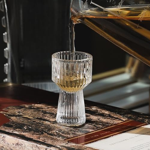 Mini Measure Shot Glass with whiskey pour on a table